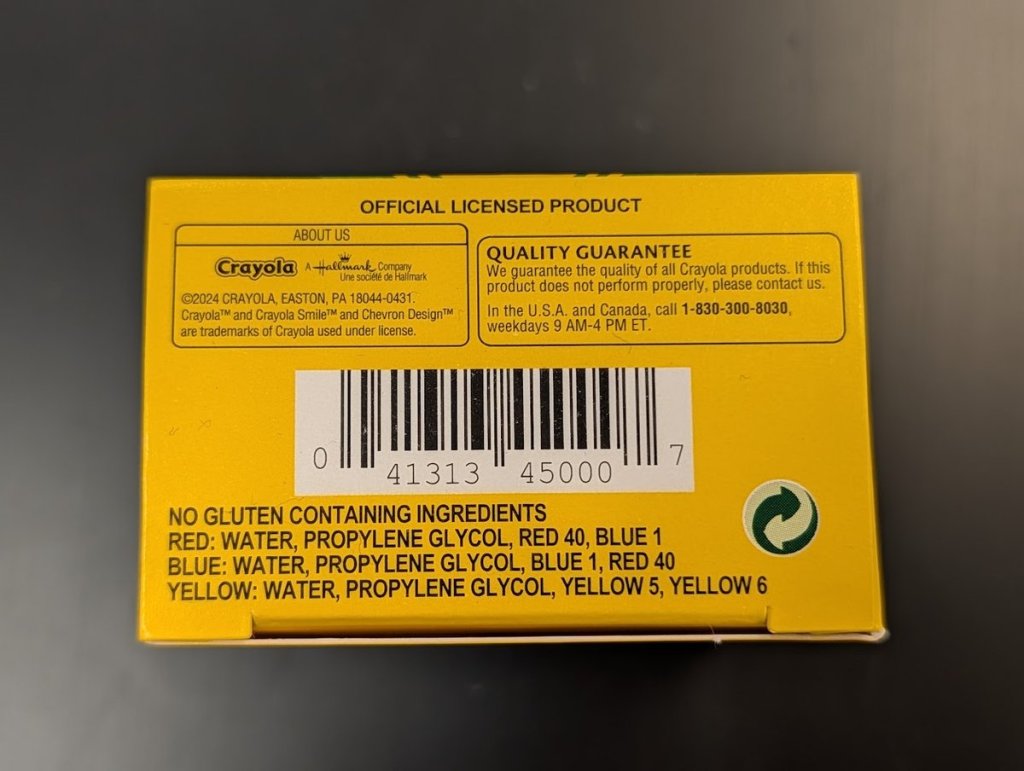 Back of a Crayola Food Colors box. The ingredients list says red contains Red 40 and Blue 1, blue contains Blue 1 and Red 40, and yellow contains Yellow 5 and Yellow 6.